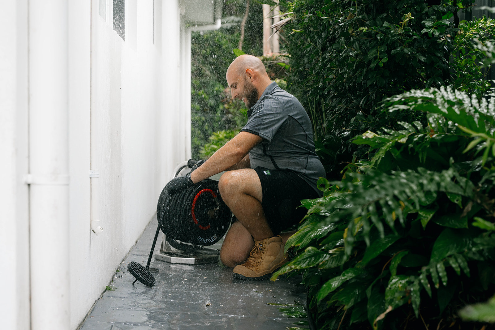 Drain camera reel set up beside a home