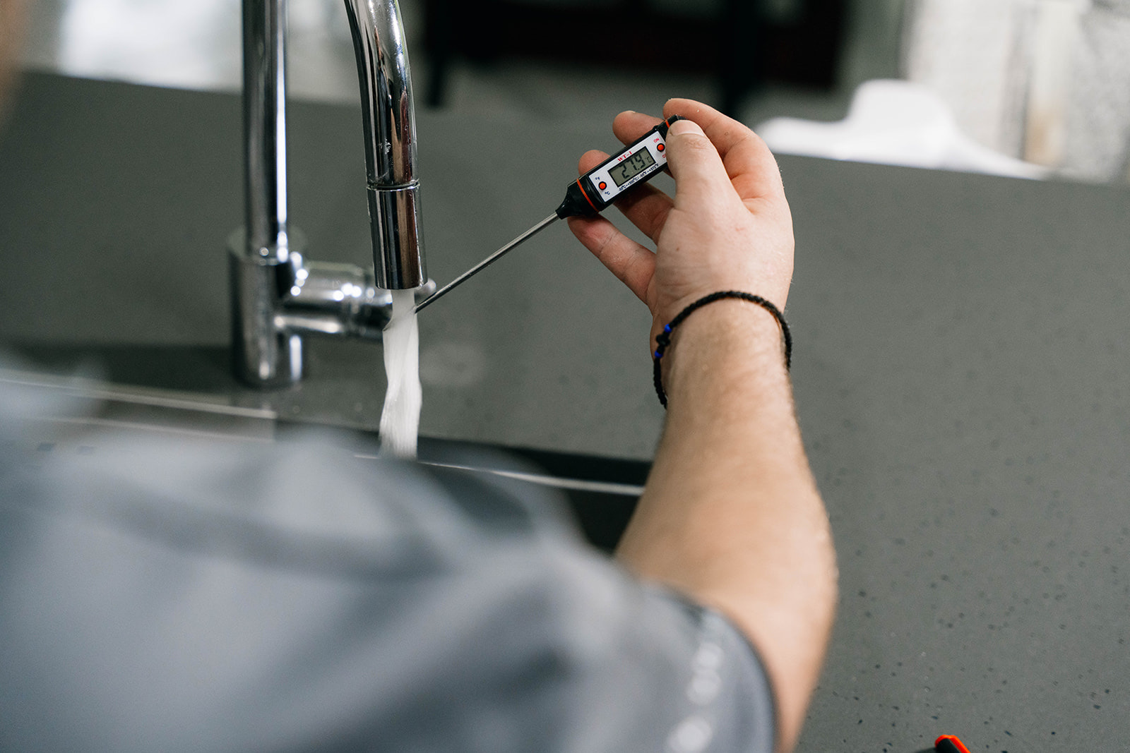 Checking water temperature at a kitchen mixer