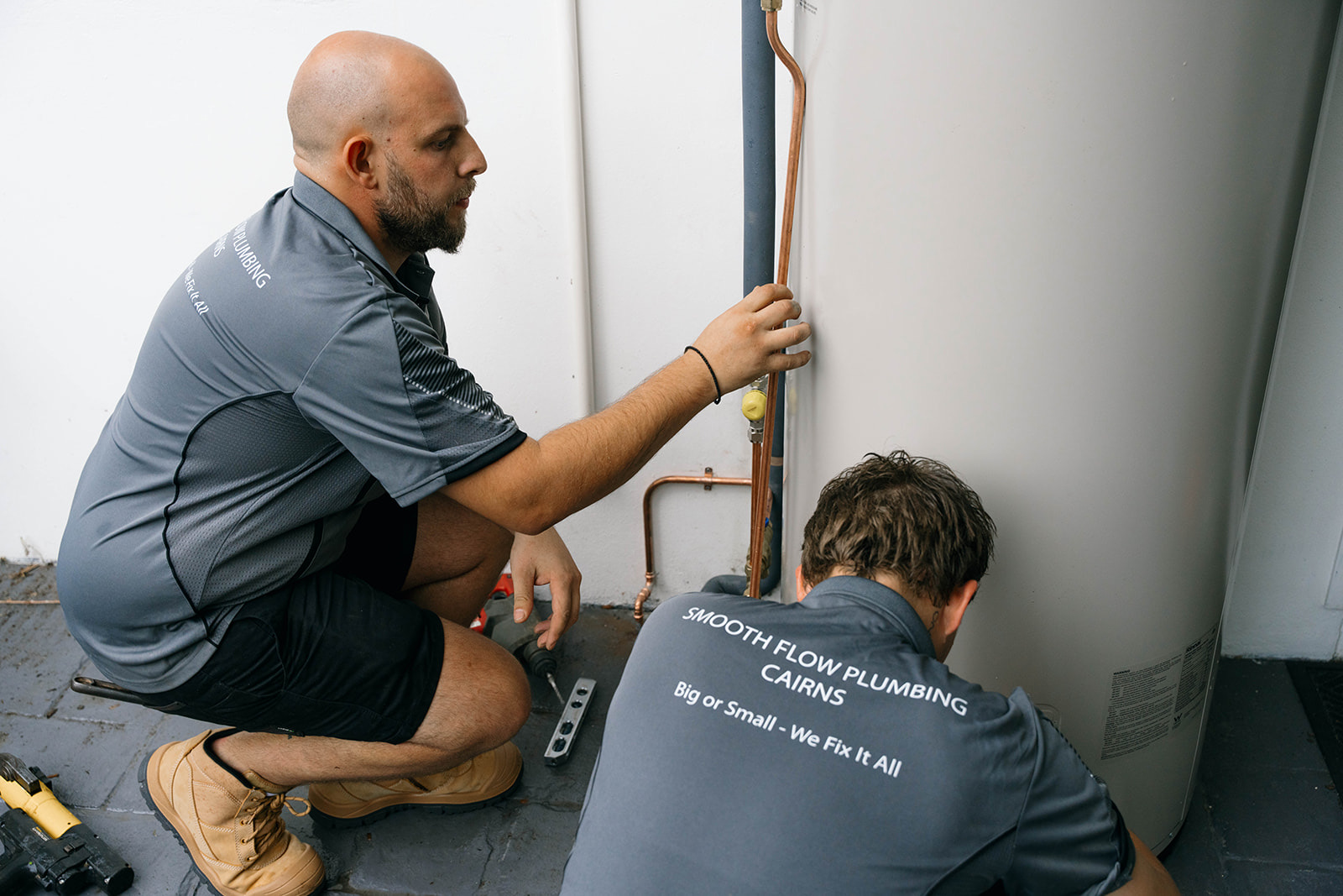 Two Smooth Flow plumbers fitting a new hot water system