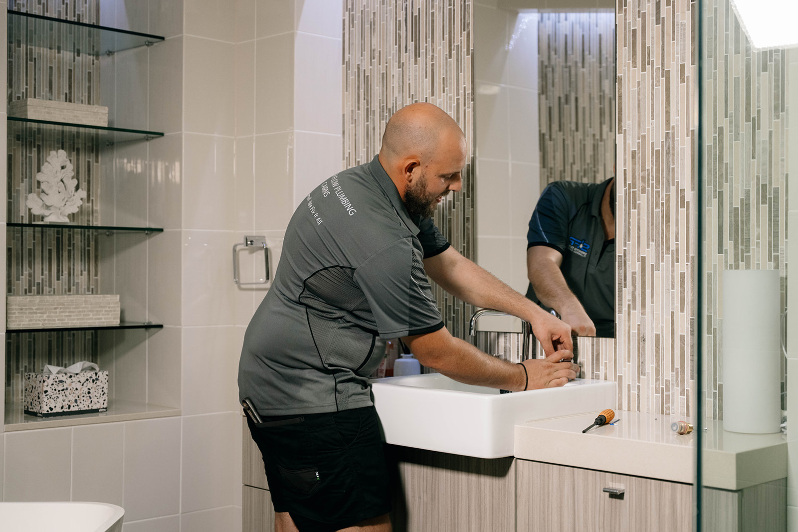 Smooth Flow plumber fitting a bathroom vanity basin